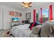 Inviting bedroom with bright red curtains, a ceiling fan, and patio access at 2639 Regency Cove Ct, Las Vegas, NV 89121
