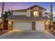 Charming two-story home featuring a three-car garage, stone accents, and manicured landscaping at 2639 Regency Cove Ct, Las Vegas, NV 89121