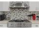 Close up of stainless steel gas range with overhead hood at 2639 Regency Cove Ct, Las Vegas, NV 89121