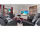 Living room featuring recliner seating, large screen television, and modern decor at 2639 Regency Cove Ct, Las Vegas, NV 89121
