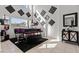 Bright living area featuring a stylish piano, modern decor, and ample natural light at 2639 Regency Cove Ct, Las Vegas, NV 89121