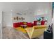 Expansive living room with bright red sofa, statement chair, and wood-look floors at 2639 Regency Cove Ct, Las Vegas, NV 89121