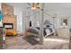 Stylish main bedroom featuring a stone fireplace, four-poster bed, and wood-look floors at 2639 Regency Cove Ct, Las Vegas, NV 89121