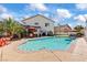 The kidney-shaped pool has a patio around it with space for chairs and an outdoor living space at 2639 Regency Cove Ct, Las Vegas, NV 89121