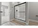 Bathroom with a large glass shower, white subway tiles, and modern fixtures, offering a sleek design at 3224 Lahontan St, North Las Vegas, NV 89032