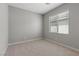 Simple bedroom with carpet flooring, a large window, and neutral-colored walls, providing a blank canvas at 3224 Lahontan St, North Las Vegas, NV 89032