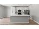 Modern kitchen with white cabinetry, stainless steel appliances, and a large island with a white countertop at 3224 Lahontan St, North Las Vegas, NV 89032