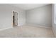 Clean bedroom with neutral carpet, base molding, large blank walls and an open closet at 3232 Lahontan St, North Las Vegas, NV 89032