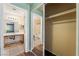 This primary bathroom features a mirrored closet next to the sink and toilet at 350 S Durango Dr # 108, Las Vegas, NV 89145