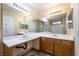 This bathroom features a double sink and a large mirror, with great lighting at 350 S Durango Dr # 108, Las Vegas, NV 89145