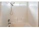 Bright shower-tub combo featuring white tile and multiple shower heads at 350 S Durango Dr # 108, Las Vegas, NV 89145