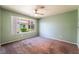 This bedroom is well-lit by a large window with neutral walls and carpeting at 350 S Durango Dr # 108, Las Vegas, NV 89145