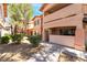 Exterior view of the two-story residential building with a desert landscape at 350 S Durango Dr # 108, Las Vegas, NV 89145
