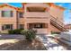 Two-story condo building with access stairs, well maintained landscaping, and desert rock at 350 S Durango Dr # 108, Las Vegas, NV 89145