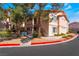 Low angle view of apartment building exterior with stairs and desert landscaping in front and visible parking restrictions at 350 S Durango Dr # 108, Las Vegas, NV 89145