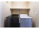 Laundry room with a gray washer and dryer, complete with an overhead shelf at 350 S Durango Dr # 108, Las Vegas, NV 89145