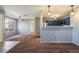 Inviting living room showcasing an open layout, neutral paint, modern light fixtures, and view of the connected kitchen at 350 S Durango Dr # 108, Las Vegas, NV 89145