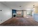 Spacious carpeted living room with a decorative fireplace, neutral wall colors, and natural light from the window at 350 S Durango Dr # 108, Las Vegas, NV 89145