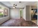 This well-lit living room features a ceiling fan and a large window, providing ample natural light at 350 S Durango Dr # 108, Las Vegas, NV 89145