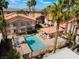 Aerial view of the Community pool and clubhouse area surrounded by lush landscaping at 350 S Durango Dr # 108, Las Vegas, NV 89145