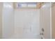 Bright shower with all white tiling and a built in seat at 350 S Durango Dr # 108, Las Vegas, NV 89145