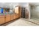 Luxury bathroom features a double vanity, marble countertops, walk-in shower, and custom storage at 360 E Desert Inn Rd # 1901, Las Vegas, NV 89109