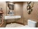 Stylish powder room with a modern sink, decorative mirror, and unique wall accents offer elegance at 360 E Desert Inn Rd # 1901, Las Vegas, NV 89109