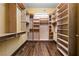 Spacious walk-in closet with wooden shelving, hanging racks, and hardwood floors at 360 E Desert Inn Rd # 1901, Las Vegas, NV 89109