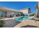 A tranquil backyard showing the pool, water slide, and the home's exterior, complete with a patio at 3832 Alder Creek Ct, North Las Vegas, NV 89032