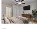 Comfortable bedroom featuring a modern bed, dresser, TV, and closet, offering a cozy and organized space at 3832 Alder Creek Ct, North Las Vegas, NV 89032