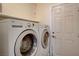 A convenient laundry room with a side-by-side washer and dryer, plus a door for easy access at 3832 Alder Creek Ct, North Las Vegas, NV 89032