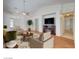 Bright and inviting living room features a fireplace, ceiling fan, and wood floors at 3832 Alder Creek Ct, North Las Vegas, NV 89032