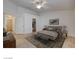 Bedroom suite boasts a king bed, sitting stools, ensuite access, and a neutral color palette at 3832 Alder Creek Ct, North Las Vegas, NV 89032