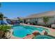 Backyard pool features rock details, water slide, and lush landscaping for a private outdoor oasis at 3832 Alder Creek Ct, North Las Vegas, NV 89032