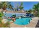 Inviting backyard pool and spa with rock accents, enhanced by colorful mural and landscaping at 3832 Alder Creek Ct, North Las Vegas, NV 89032