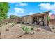 View of landscaped backyard with desert plants, covered patio and view of home at 40 Vicolo Della Luna, Henderson, NV 89011