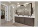 Bright bathroom with double sinks, a large mirror, walk in shower and a walk in closet at 40 Vicolo Della Luna, Henderson, NV 89011