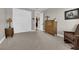 Comfortable bedroom with a wooden dresser, sitting chair, and closet with sliding doors at 40 Vicolo Della Luna, Henderson, NV 89011