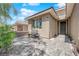 Cozy front entrance with a tiled patio, comfortable seating, and attractive landscaping; warm welcome at 40 Vicolo Della Luna, Henderson, NV 89011