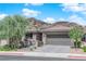 Charming single-story home with a two-car garage, neat landscaping, and a picturesque mountain backdrop at 40 Vicolo Della Luna, Henderson, NV 89011