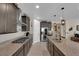 Modern kitchen featuring granite countertops, stainless steel appliances, and plenty of cabinet space for storage at 40 Vicolo Della Luna, Henderson, NV 89011