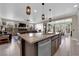 Open-concept kitchen flowing into a living area, showcasing a large island and contemporary design, ideal for gatherings at 40 Vicolo Della Luna, Henderson, NV 89011