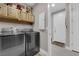 Convenient laundry room with a washer, dryer, cabinets, and a door leading outside at 40 Vicolo Della Luna, Henderson, NV 89011