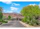 Charming home exterior with mature trees and landscaping along a quiet street at 40 Vicolo Della Luna, Henderson, NV 89011
