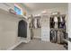 Organized walk-in closet with ample shelving and hanging space for clothes and accessories at 40 Vicolo Della Luna, Henderson, NV 89011