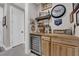 Charming wet bar with decorative shelving, wine fridge, and ample counter space for drinks at 40 Vicolo Della Luna, Henderson, NV 89011