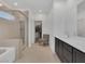 Modern bathroom featuring a walk-in glass shower, soaking tub, and dual sink vanity at 4246 W Landberg Ave, Las Vegas, NV 89141