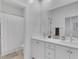 Clean, bright bathroom with double sinks, white cabinets, and a shower-tub combination at 4246 W Landberg Ave, Las Vegas, NV 89141