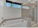 Bathroom featuring soaking tub and glass shower with bright natural light at 4246 W Landberg Ave, Las Vegas, NV 89141