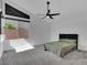 Minimalist bedroom features soft carpet, large window and contemporary ceiling fan at 4246 W Landberg Ave, Las Vegas, NV 89141